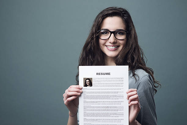 istock Young woman holding her resume 587813534
