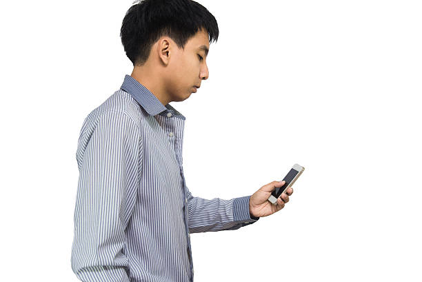istock Young man typing text message on his cellphone against 587813736