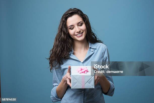 Girl Giving A Beautiful Gift Stock Photo - Download Image Now - Gift, Holding, Women