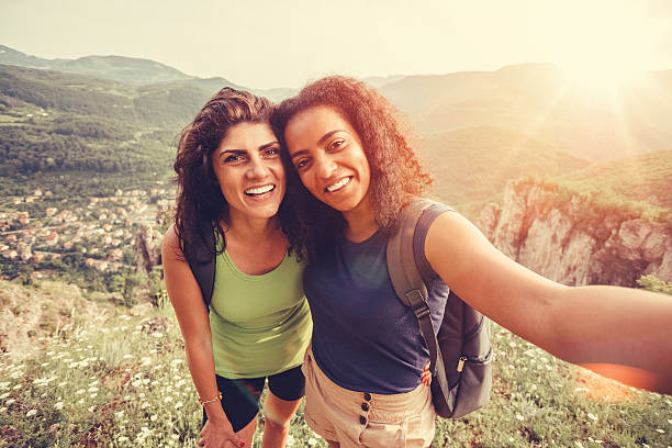 Young women taking selfie among nature
