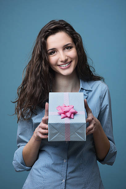 istock Girl giving a beautiful gift 587814940