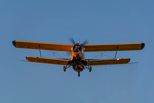 istock Crop duster spraying crops from the air 587815228