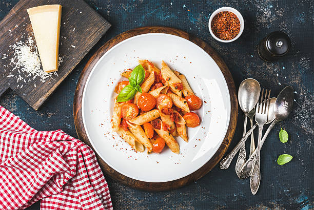 Pasta penne with tomato sauce, basil and roasted tomatoes