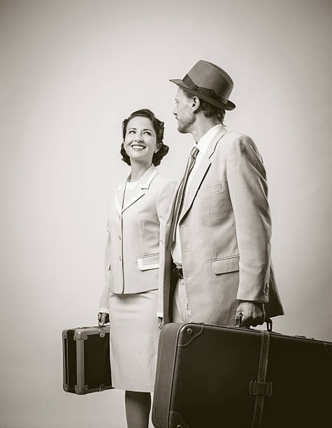 istock Elegant couple leaving with luggage 587815600