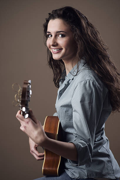 istock Beautiful girl playing guitar 587815862