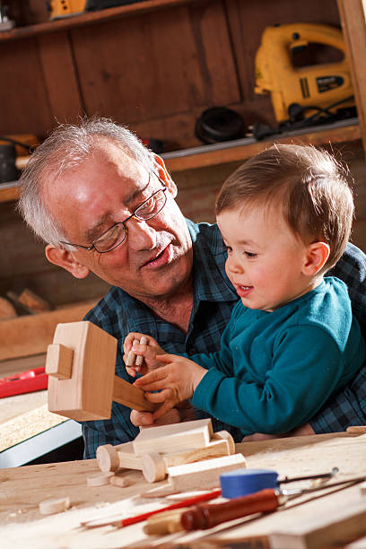 istock Grandfather and grandson in workshop 587816436