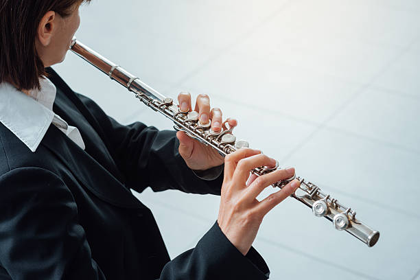 istock Woman playing transverse flute 587816944