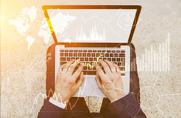 istock Laptop with business charts toning 587817028