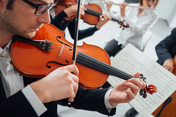 istock Violinist performing with music sheet 587817064
