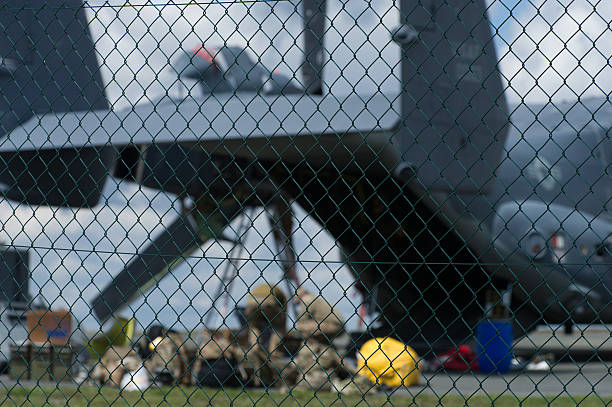 Bindlach, Bavaria, Germany - August 11, 2016: Military Aircraft Type Bell-Boeing V-22 Osprey behind the fence at the cuvil airfield of Bindlach (Germany). The aircraft had an unpredictable landing at Tuesday August 9th. No are soldiers and mechanician repairing the engine soon as possible. The aircraft was on the way to Poland for a Nato exercise.  