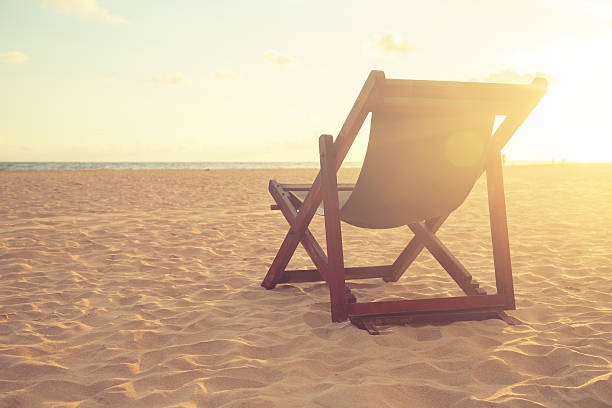 Two Beach Chairs standing in beach with beautiful sea and sunlight in background at island in Phuket, Thailand. Summer, Travel, Vacation and Holiday concept.