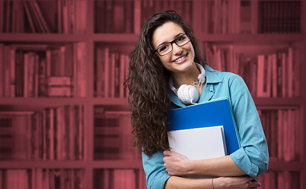 Beautiful student girl posing with notebooks