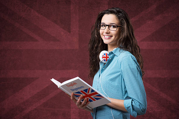 Beautiful student girl posing with notebooks Beautiful student girl posing with an open book and smiling britain british audio stock pictures, royalty-free photos & images