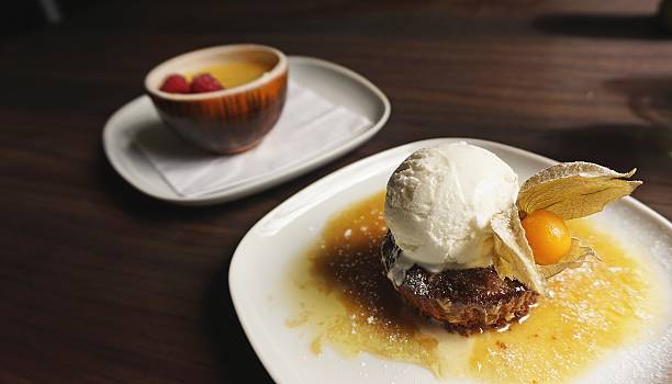 istock Sticky toffee pudding served with ice cream 587820266