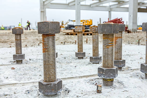 istock Anchor's nuts on screw are peaking from concrete in building. 587820294