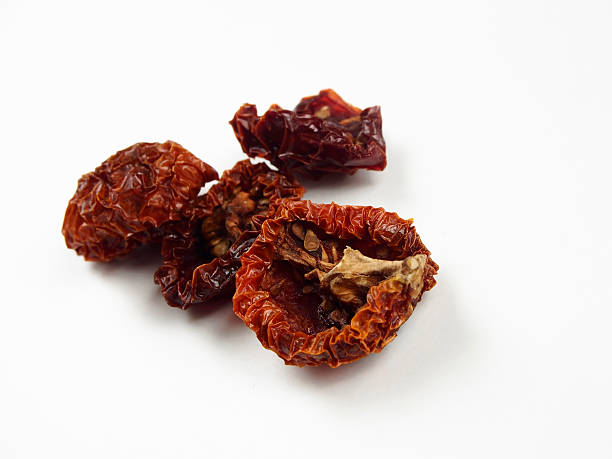 istock Dried tomatoes in recipiente on white backgroundo 587820554