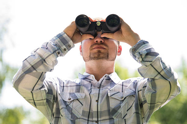 istock Man with Binoculars outdoors 587882772