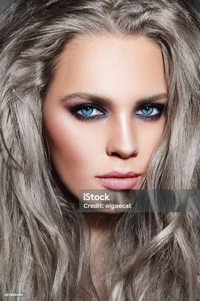 Messy hairstyle Close-up portrait of young beautiful woman with long grey hair and stylish smoky eyes make-up Gray Hair Stock Photo