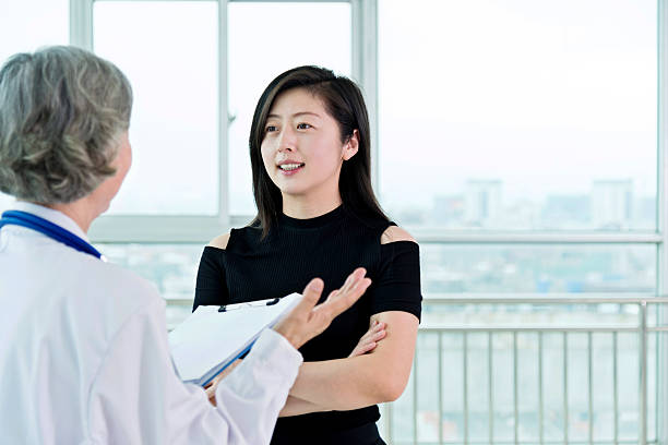 istock Senior female doctor talking to her patient 587884920