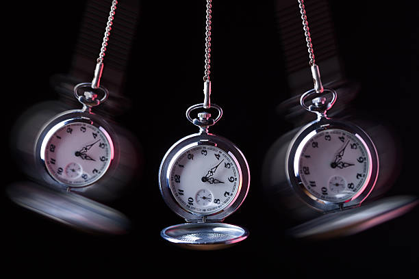 istock Pocket watch swinging on a chain to hypnotise 587886046