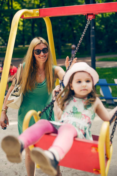 istock Modern Mother with Her Daughter at Playground 587888390