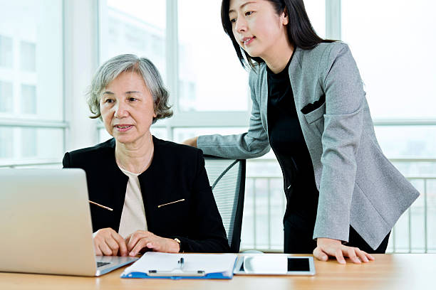 istock Two businesswomen working together in modern office 587889272