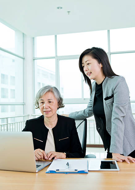 istock Two businesswomen working together in modern office 587889460