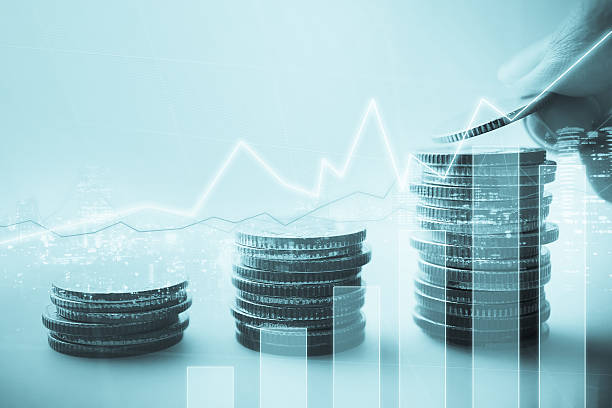 istock Double exposure of graph and rows of coins 587890986