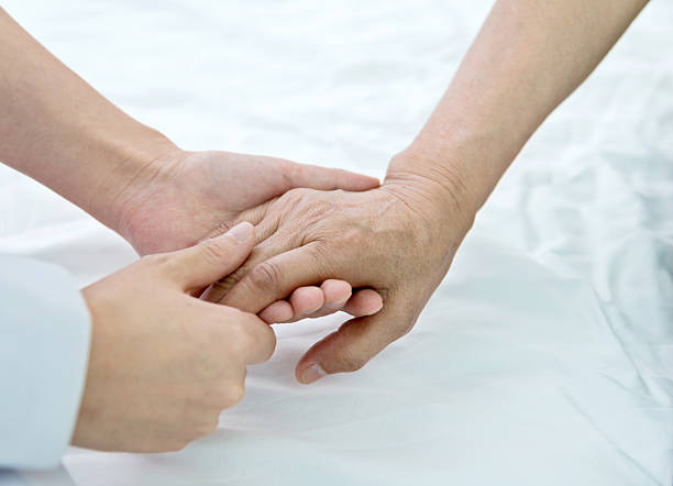 istock Young hands holding a senior woman's hands 587895096
