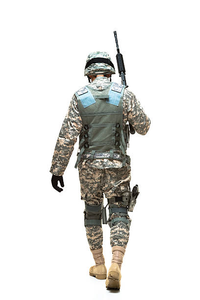 istock Rear view of army man walking 587895566
