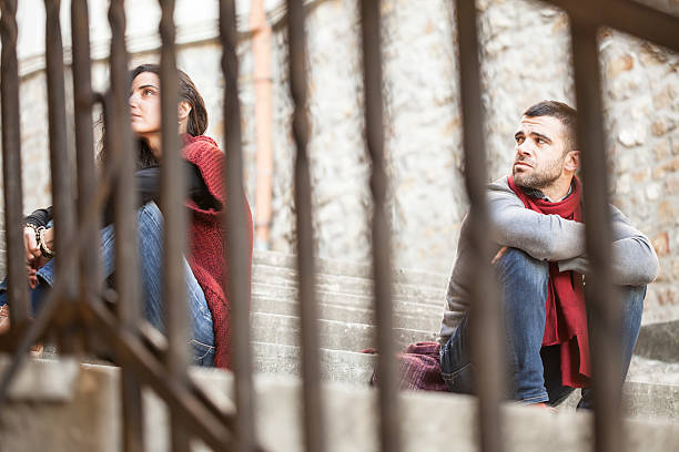 istock Young couple with relationship difficulties sitting on stairs 587898076