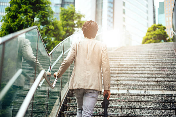 istock Success ladders for young Japanese businessman 587899468