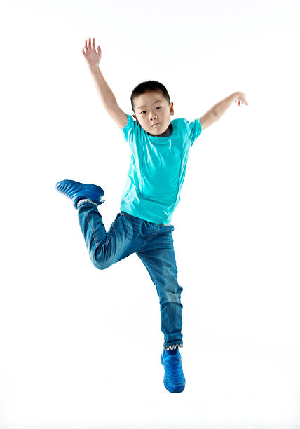istock Young asian boy jumping against white background 587899958
