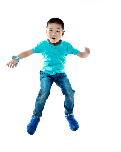 istock Young asian boy jumping against white background 587900022
