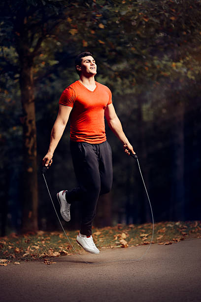 istock Fitness Man Skipping Rope Outdoors in Nature 587901624