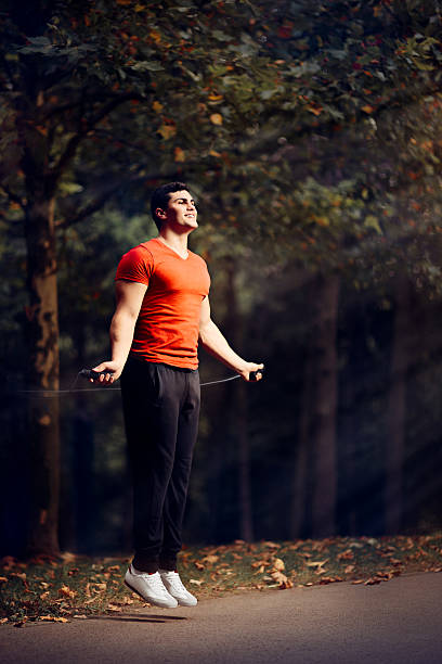 istock Fitness Man Skipping Rope Outdoors in Nature 587901634