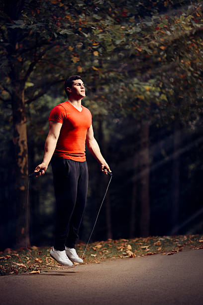Fitness Man Skipping Rope Outdoors in Nature