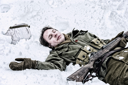 Fatality of WWII - US Soldier.  He is laying in the snow bleeding from a bullet wound in the chest.