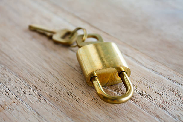 istock Golden padlock on wood background 587902854