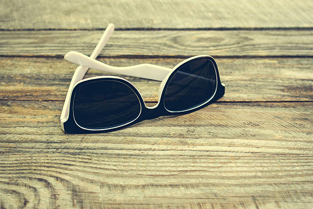 istock Sunglasses on wooden background. 587903800