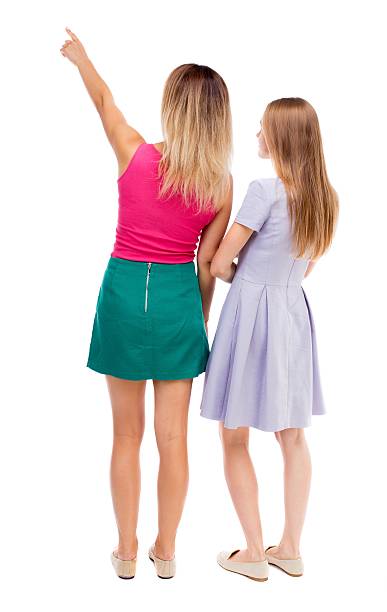 istock Back view of two pointing young girl. 587904242