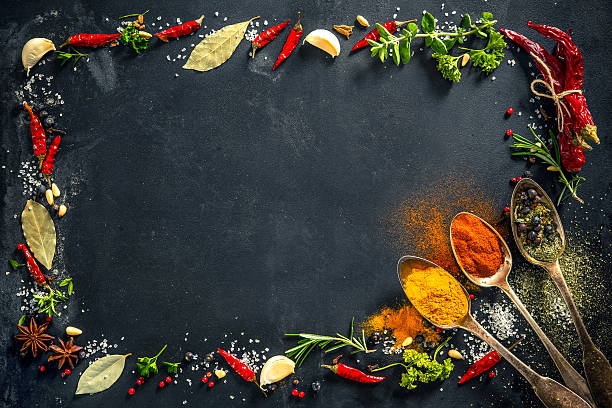 istock Herbs and spices over black stone background 587904652