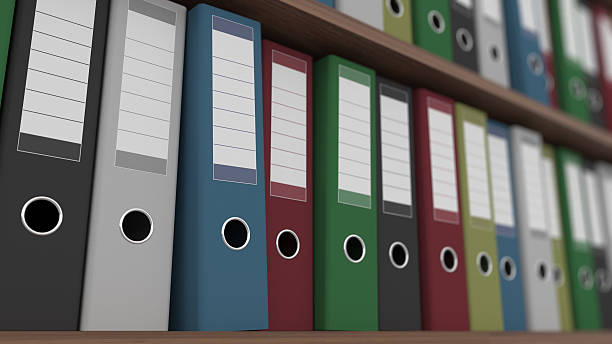 istock Rows of multicolored binders on shelves close up shot, shallow 587905374