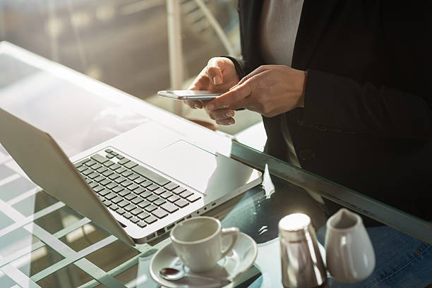 istock Businesswoman texting with her smart phone 587911488