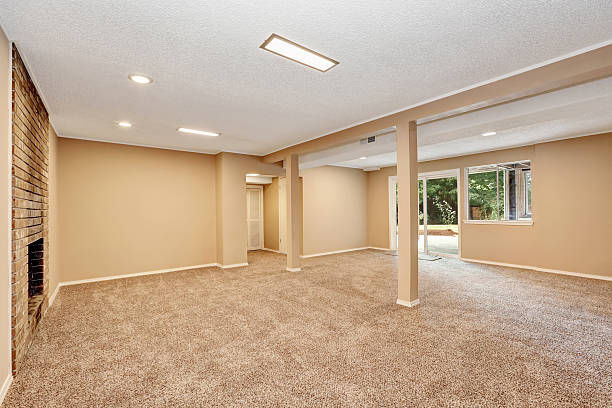 istock Empty spacious room with brick fireplace and carpet floor 587913002