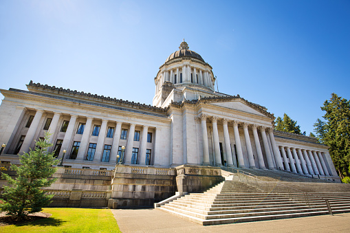 Subject: The Washington state capitol building exterior, it houses the State Senate, House of Representatives, the office of the Governor. Located in Olympia, Washington. Photographed in horizontal format.