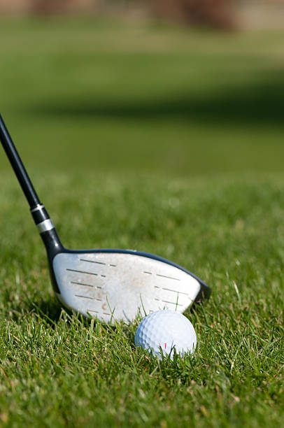istock Golf ball and golf club in green grass 587920646