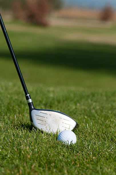 istock Golf ball and golf club in green grass 587920728