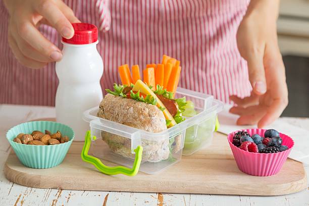 istock Mother making school lunch in the kitchen 587921326