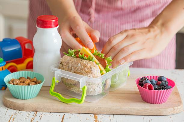istock Mother making school lunch in the kitchen 587921456